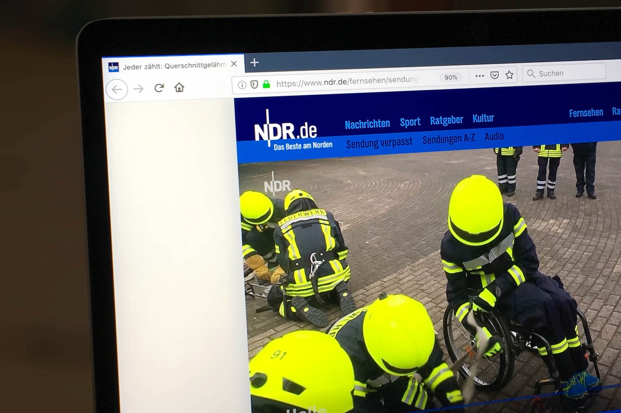 Foto der NDR-Seite, auf der der Video-Beitrag zu sehen ist. Das Standbild zeigt Finn-Niklas Gerken in Feuerwehrkleidung in seinem Rollstuhl, umgeben von seinem Team.